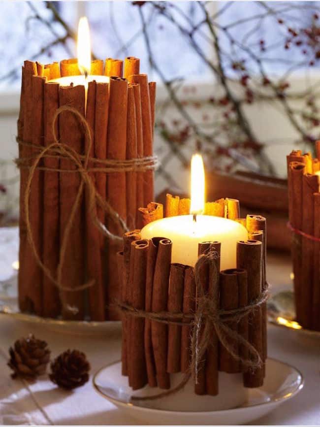 Pillar candles wrapped in cinnamon sticks